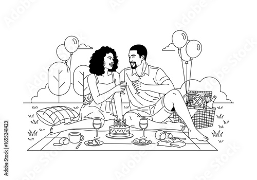 African-American couple enjoying a romantic picnic celebration with cake and drinks