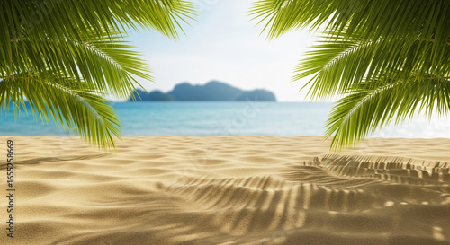 Fototapeta Naklejka Na Ścianę i Meble -  Sandy beach scene framed by palm leaves, ocean and distant islands blurred in background, showcasing free space for text or product placement, ideal for summer or travel advertisement