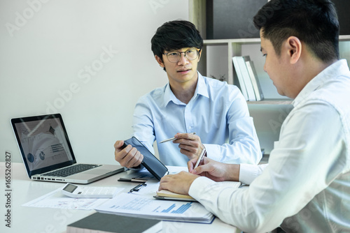Two business partner team meeting and discussion financial project of investment ideas, presentation and analyzing marketing planning strategy of business making to growth profit and successful