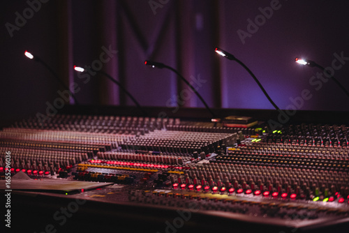 Professional Audio Mixing Console with Illuminated Controls and Equipment