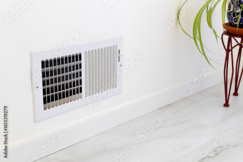 Supply air vent installed in the room. Air register placed near the floor
