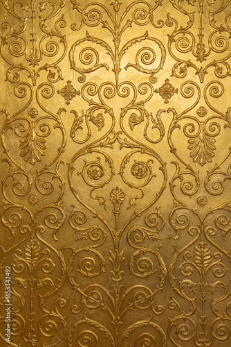 Intricate Gold-Patterned Wall Designed With Floral Motifs and Swirls