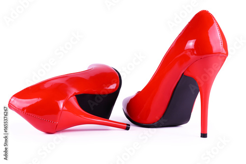 Close-up of elegant glossy red stiletto high heels on white background. Stylish womens fashion shoes perfect for glamorous outfits, evening wear, luxury accessories and modern fashion advertising.