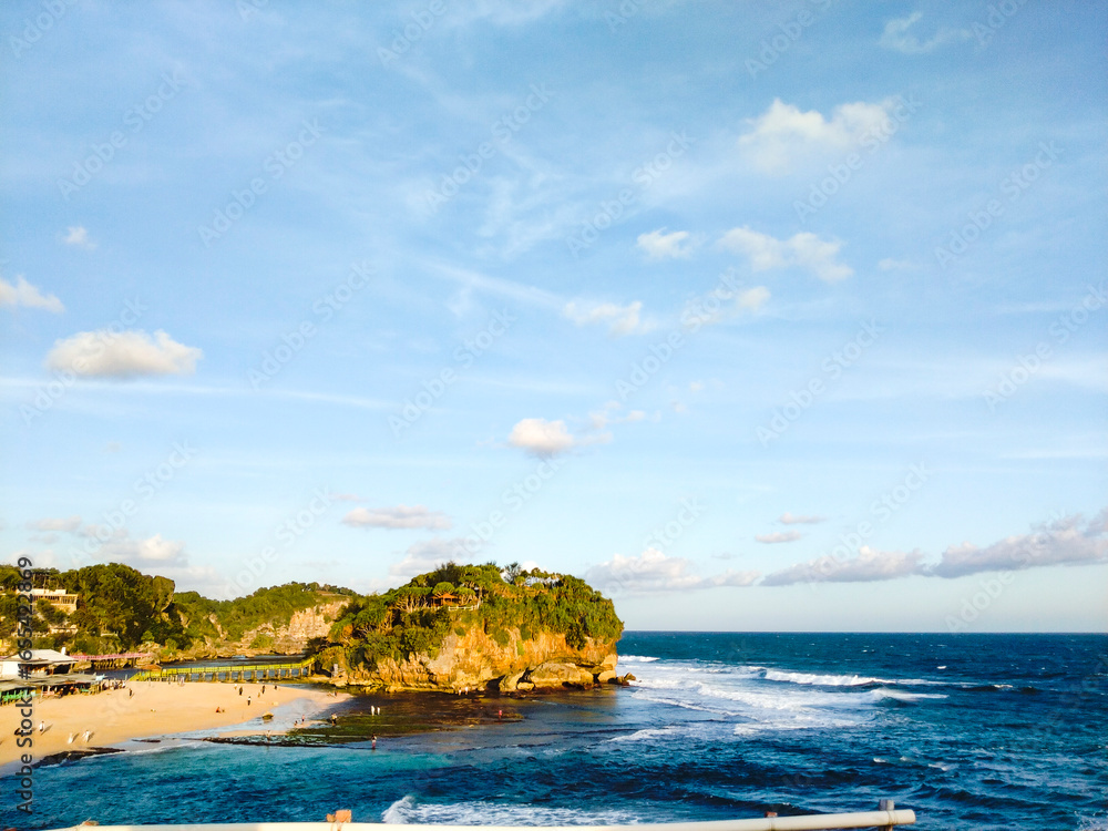 Fototapeta premium Beautiful view of the Drini beach with coral and blue sky from a high point of view. Beautiful beaches of Yogyakarta, Indonesia
