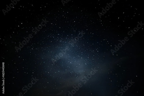 Starry night sky, dark and vast.  Many tiny stars, a subtle cloud