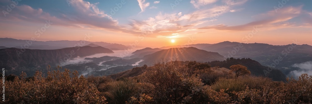 Obraz premium Sunset over a mountain valley.