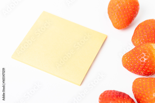 A yellow piece of paper with a blank space sits on a white background