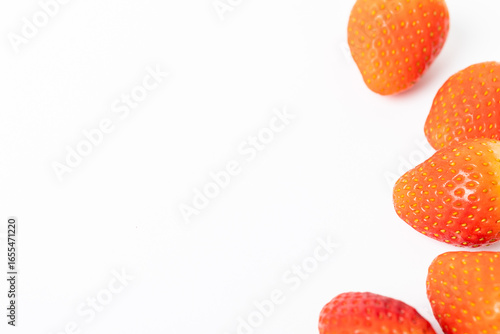 A close up of a bunch of strawberries on a white background