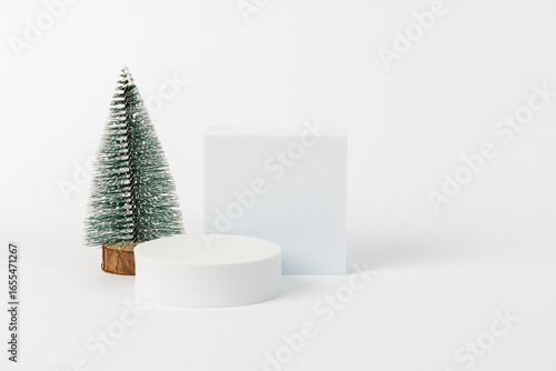 A white box with a green tree in front of it