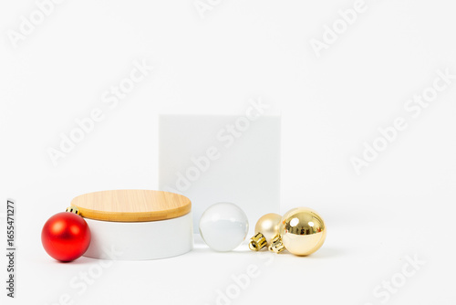 A white square with a red and gold ball on top of it