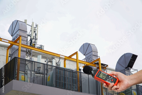 Pollution is too loud.Hand of Environmental officer holding to use sound level meter for monitor is part of the prevention of environmental impact,Noise reduction concept for residential communities