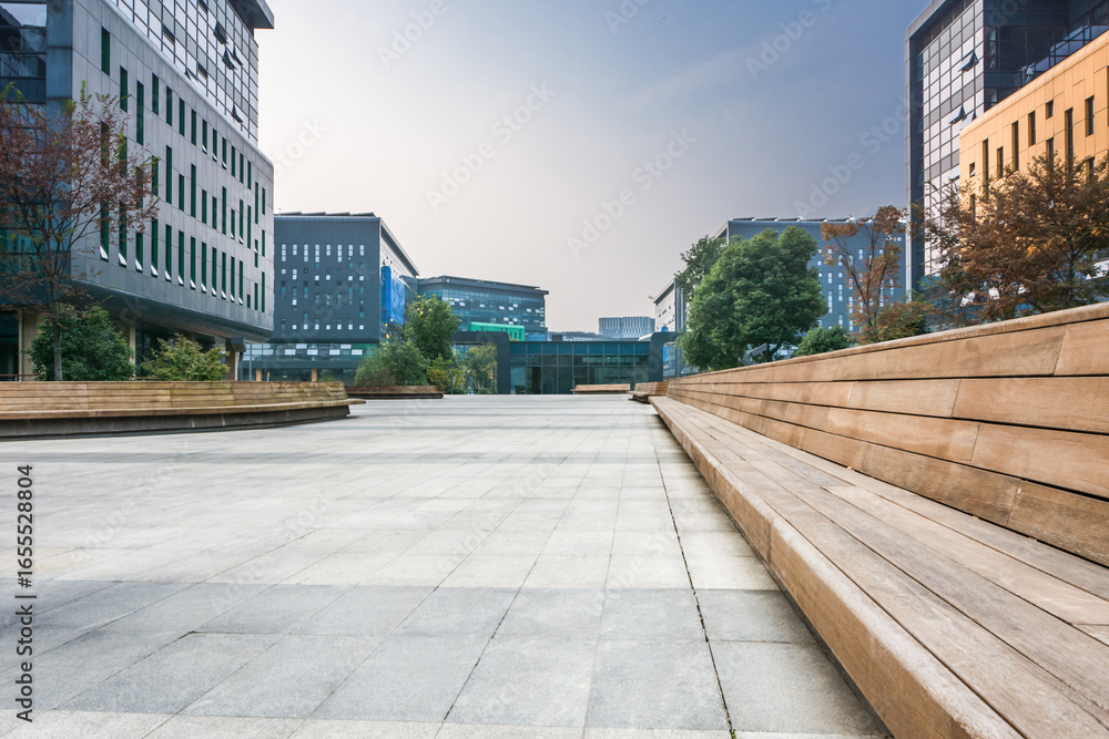 Fototapeta premium Serene Urban Plaza with Modern Architecture and Natural Elements