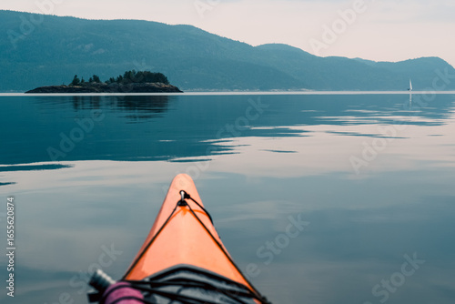 Kayak on Calm Waters with Island and Mountain Views Ahead