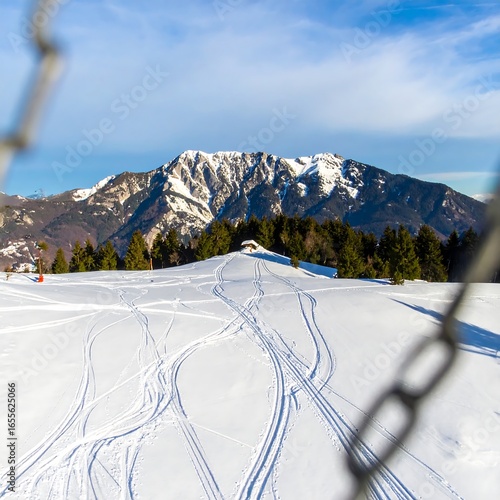 Snowy mountain vista with ski tracks