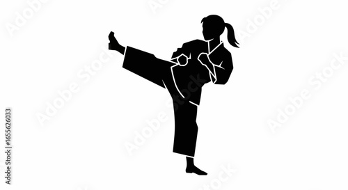 Silhouette of a woman performing a dynamic side kick in martial arts attire.