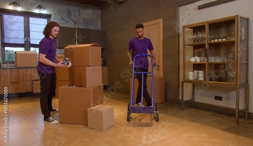 Mover kneeling and handing off a protected item during packing process.