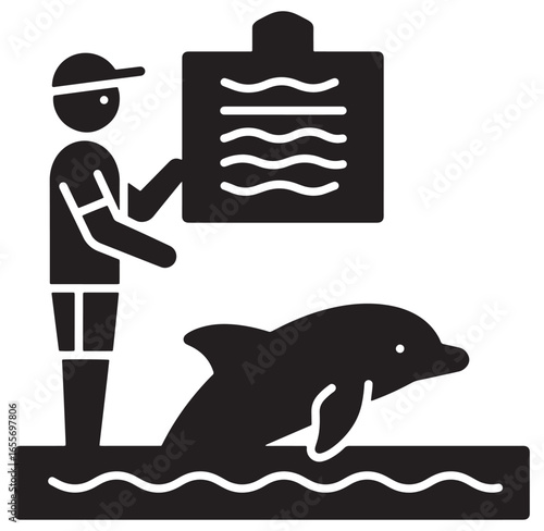 Dolphin trainer shows training program information near a jumping dolphin during a show