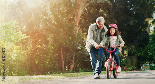 Bild auf Leinwand Teaching, grandfather and child on bicycle outdoor with safety, learning skills and development