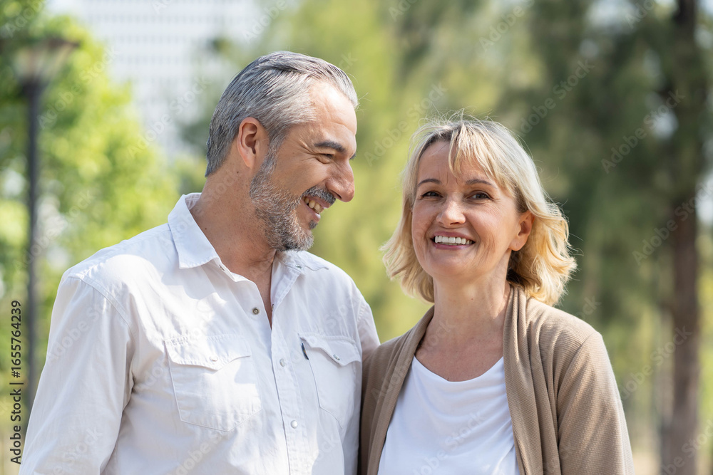 Elderly couple lifestyle concept. Husband embrace wife and sit on seat in the park relax on retirement life. Elderly couple lifestyle concept. Husband embrace wife and sit on seat in the park relax on retirement life.