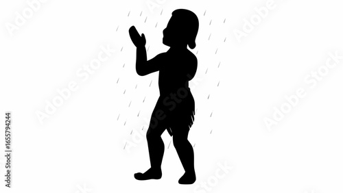 Silhouette of a child standing in the rain with hands raised looking up at the sky with raindrops falling