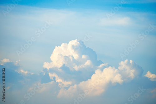 Towering clouds glowing under the soft evening sky