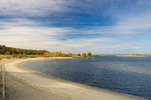 Wallpaper Mural Wide Dnieper River flowing near Kaniv in Ukraine on a sunny autumn day, featuring a sandy beach and calm waters that create a serene and picturesque landscape Torontodigital.ca