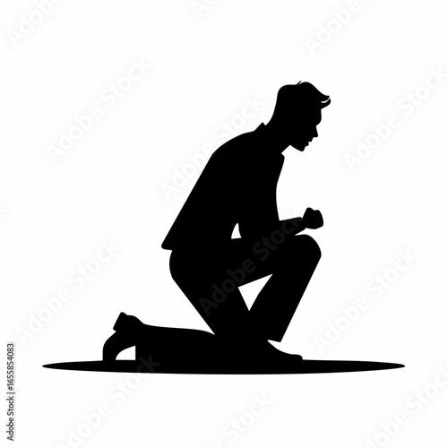 Silhouetted Solemnity: A poignant silhouette of a man kneeling, head bowed in a moment of quiet reflection, offering a profound look at faith and humility.