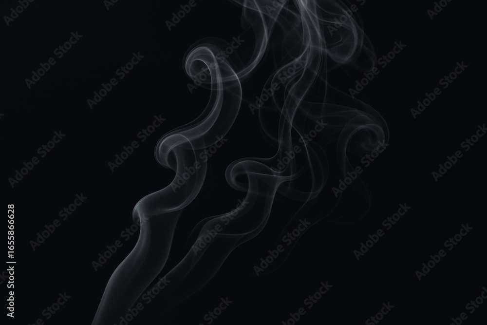 Obraz premium Elegant White Smoke Trails Against Dark Backdrop, Creates Abstract and Dramatic Visuals for Various Creative Projects