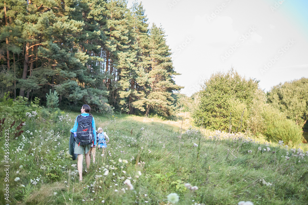Obraz premium Mother and children hiking in the forest