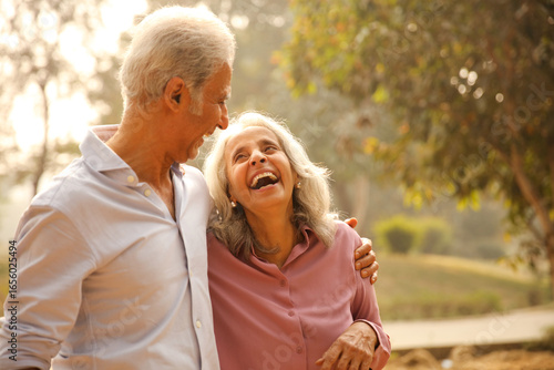 Seniors Enjoying A Joyful Moment In A Sunlit Park