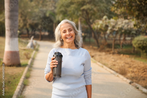 Most Beautiful Old Woman Walks In Park Holding Reusable Water Bottle