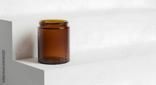 Amber glass jar with a yellow cap, displayed on a minimalist white geometric surface. Perfect for modern product packaging, health supplements, or cosmetic design mockups