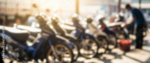 Wallpaper Mural Row of motorcycles parked with a person working near them outdoors, reflecting everyday street scene, authentic culture of motorbike use, and community activity in an open environment. Torontodigital.ca