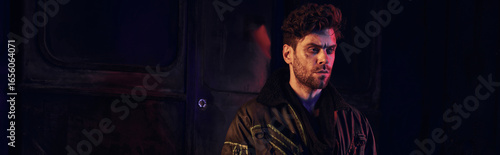 Determined young man stands amidst the ruins of a post apocalyptic landscape, embodying resilience.