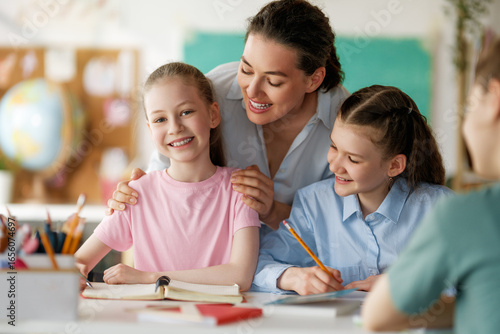 Happy kids and teacher at school