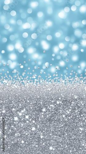 Shimmering silver glitter and sparkling bokeh on a blue background for festive celebrations
