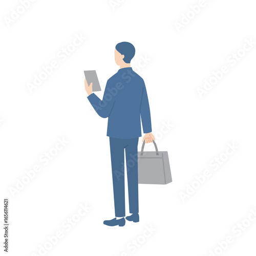 ビジネスバッグを持ってスマホを確認しているビジネスマンの後ろ姿