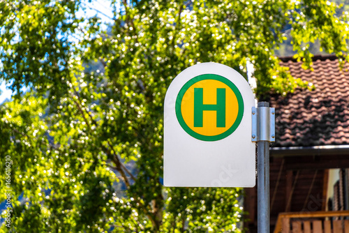 Green and yellow bus stop sign in Tyrol Austria.