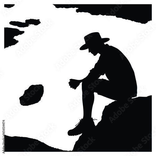 Silhouette of a person sitting on a rock overlooking a mountain landscape
