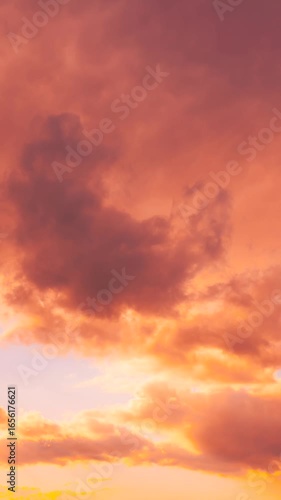 Sunset Cloudy Sky With Fluffy Clouds. Sunset Sky in pink orange colors Background. Dramatic Sky. sunrise Sunset Time Lapse Time-Lapse In Yellow, Orange, Pink Colors