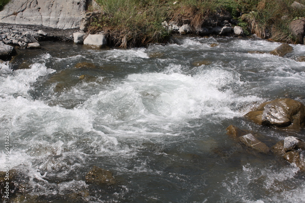 Fototapeta premium water flowing over rocks