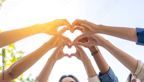 Diverse hands forming a heart shape, bright sunlight, hopeful and optimistic mood, teamwork concept, unity, collaboration, friendship, positive energy, community support.