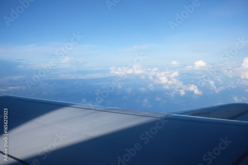 Aerial View from Airplane Window Over Fluffy Clouds Focus on Foreground