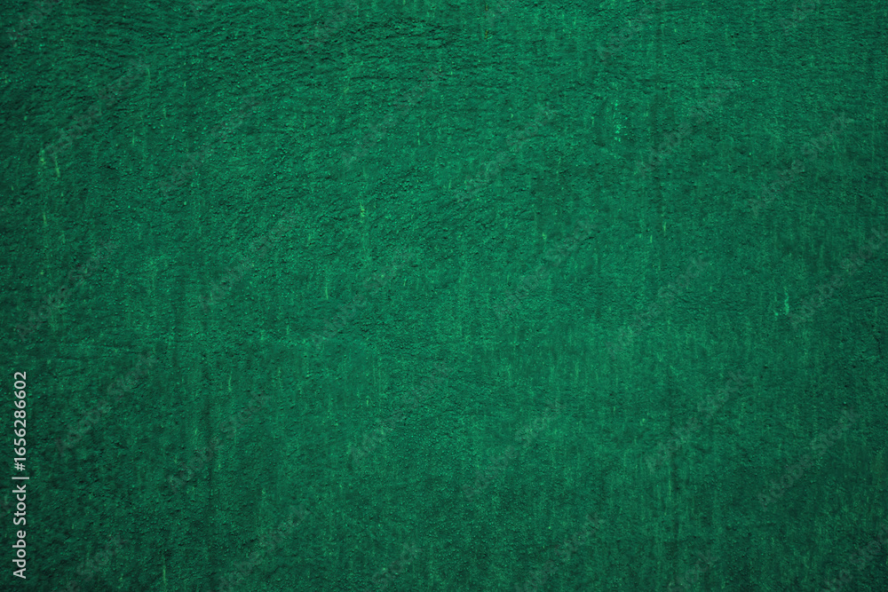 Fototapeta premium Dark green matte background, embossed textured wall.