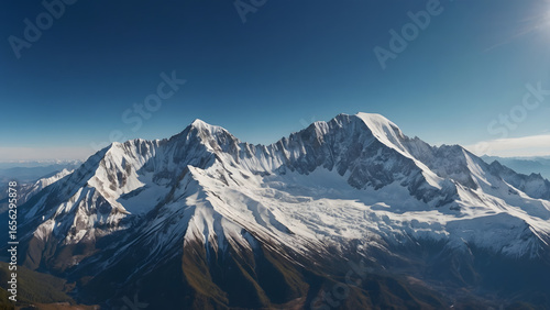 Wallpaper Mural Majestic snow-capped mountain range bathed in crisp sunlight under a clear blue sky Torontodigital.ca
