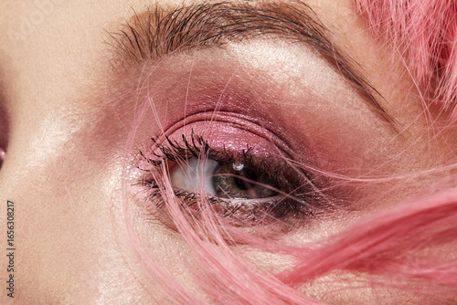 Closeup Macro of Pink Fashion Eye Make-up. Expressive Makeup, Bright Summer Eyeshadows and Magenta Color Hair. Perfect for party, holiday or Valentines Day style