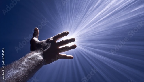 Hand reaching towards bright light