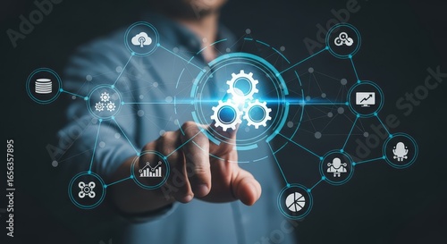 Businessman touching a digital interface with automation icons