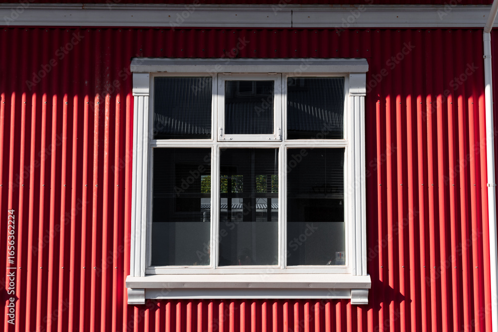 Fototapeta premium House with red exteior wall and white window.