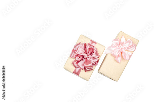 Eco-friendly gift boxes wrapped in kraft paper and decorated with satin ribbons isolated on white